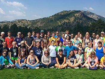 A group of Honors Students sitting in front of a mountain at YMCA, Estes Park Colorado